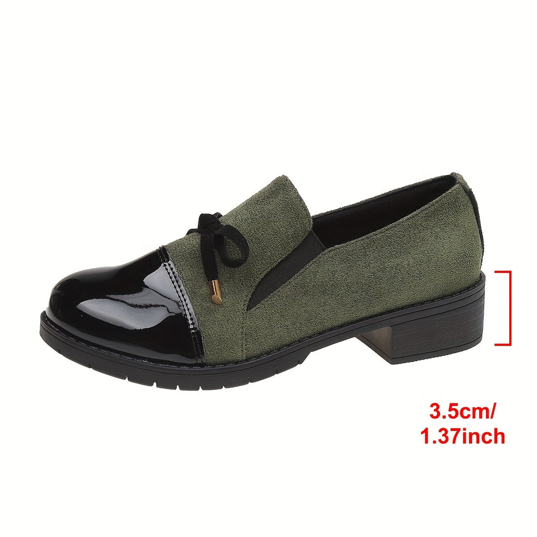 Women's slip-on loafers in black, offering elegant comfort, a low heel, and a chic bow design.