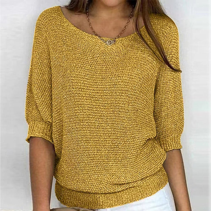 Women's round neck batwing sweater. Oversized knit top for a relaxed, stylish, and cozy winter look.