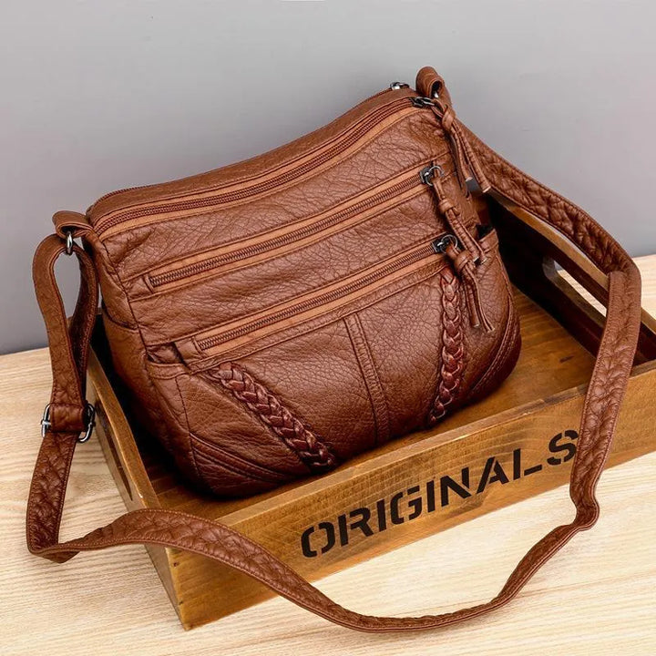 Elegant women's soft genuine leather crossbody bag in black. Versatile, durable everyday fashion accessory.