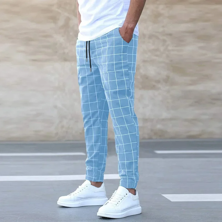 Men's stylish blue plaid joggers with tapered fit, perfect for casual wear and modern streetwear fashion.