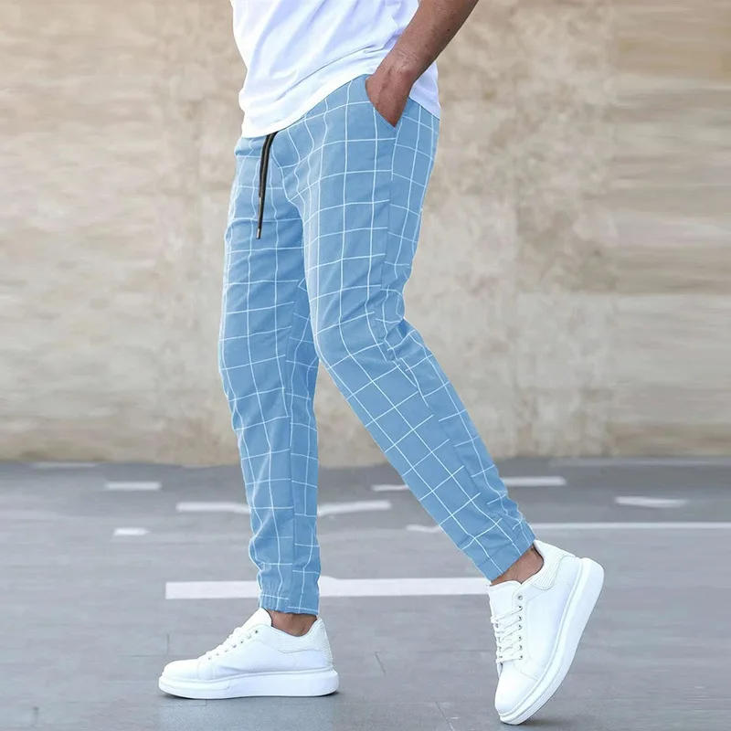 Comfortable men's tapered plaid joggers in a navy blue pattern, ideal for relaxed casual or streetwear outfits.