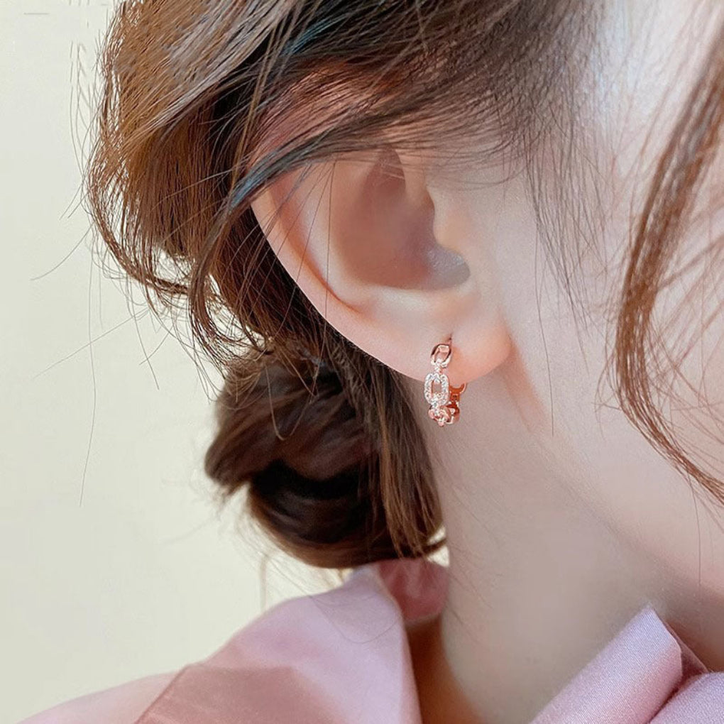 Close-up of delicate women's diamond inspired stud earrings, offering minimalist and elegant style.