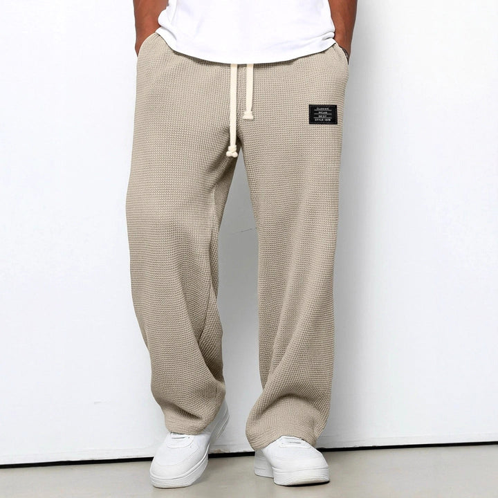 Side profile of men's everyday trousers, showcasing the relaxed fit and classic straight-leg style.