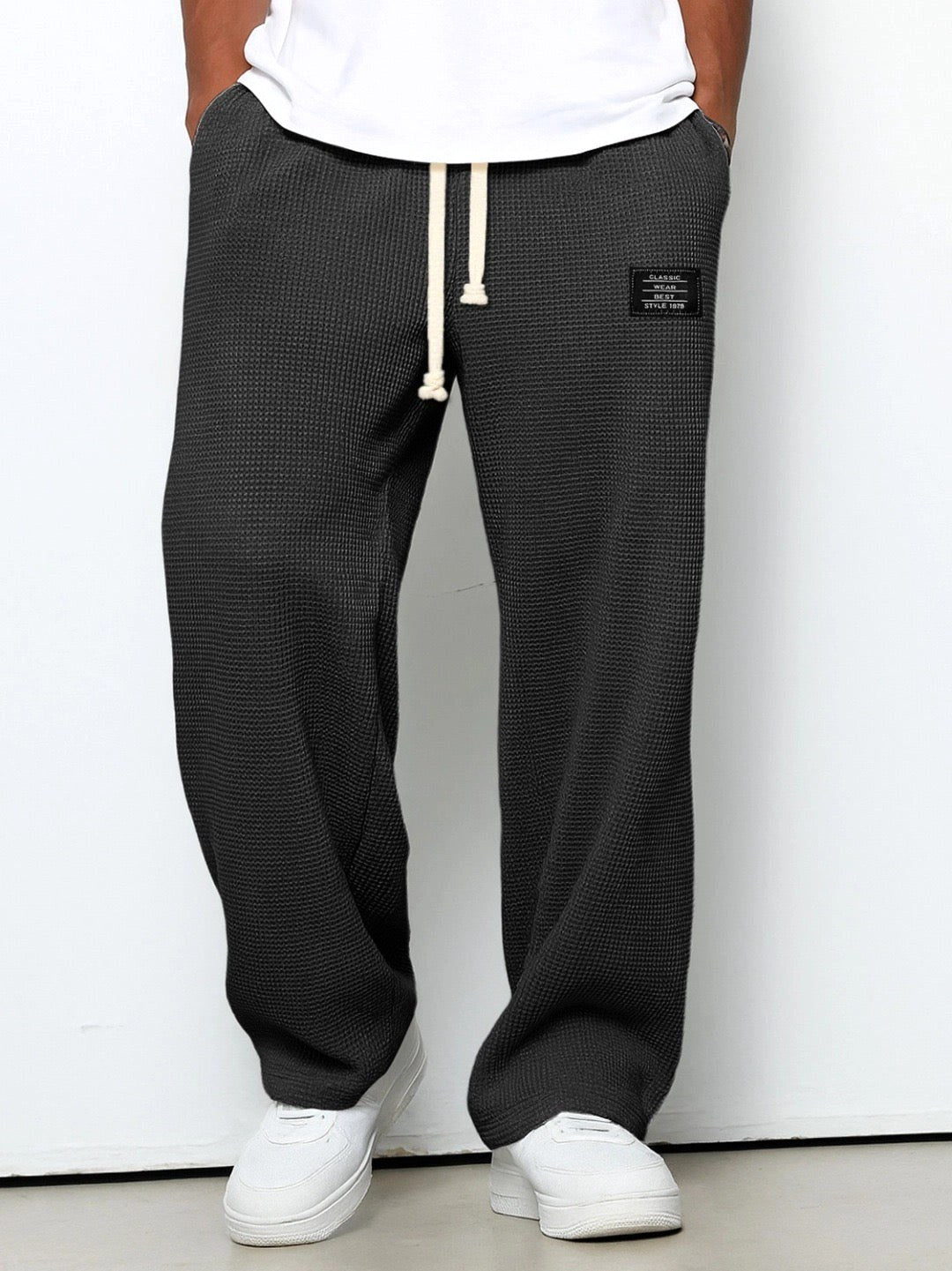 Back view of men's straight-leg everyday trousers, highlighting practical pockets and relaxed silhouette.