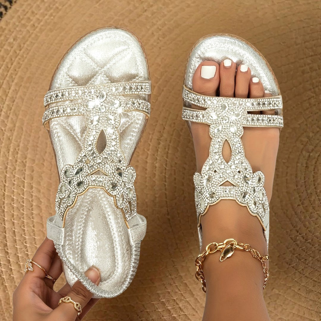 Comfortable women's flat sandals with rhinestone accents, ideal for stylish everyday wear.