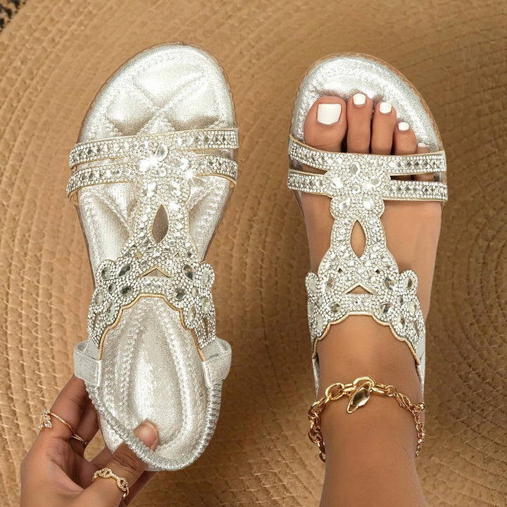 Comfortable women's flat sandals with rhinestone accents, ideal for stylish everyday wear.