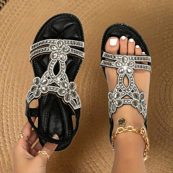 Elegant women's flat sandals featuring rhinestone details and orthopedic arch support for comfort.