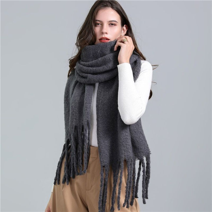 Essential women's winter scarf, a warm and soft checked accessory for cold weather fashion.