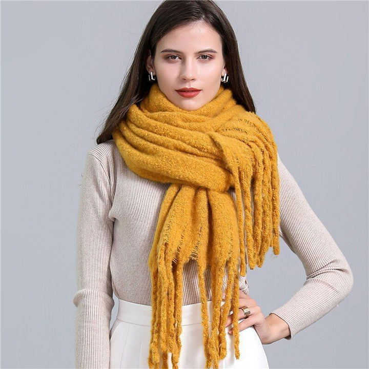 Women's luxurious soft checked winter scarf with playful tassels, a chic and warm accessory.