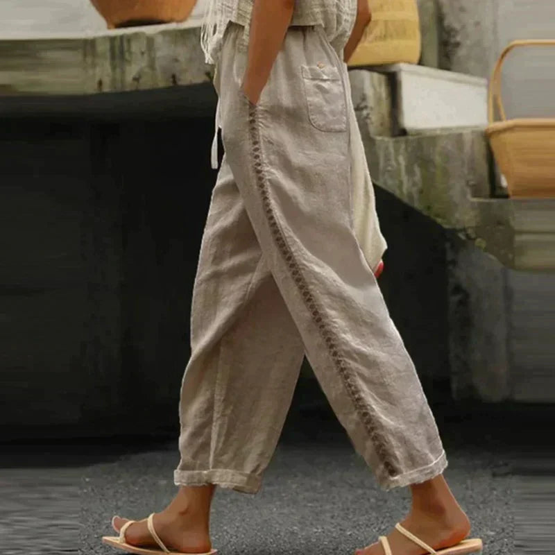 Modern women's high waist tapered leg pants with chic button detail. Offers a comfortable & flattering fit.