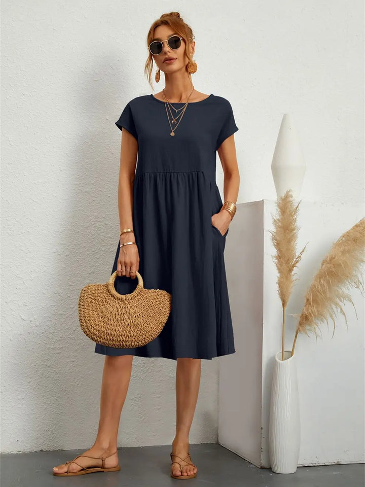 Modern women's casual A-line midi dress, short-sleeved, with pockets for everyday fashion.