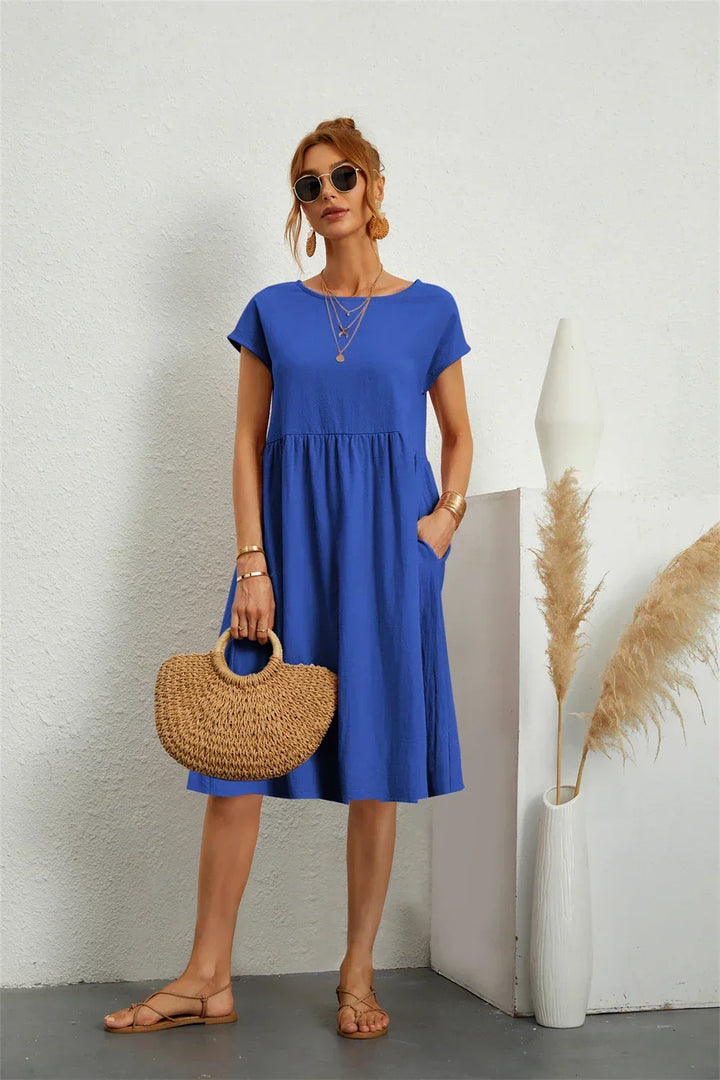 Comfortable short-sleeve A-line midi dress for women, featuring convenient pockets.