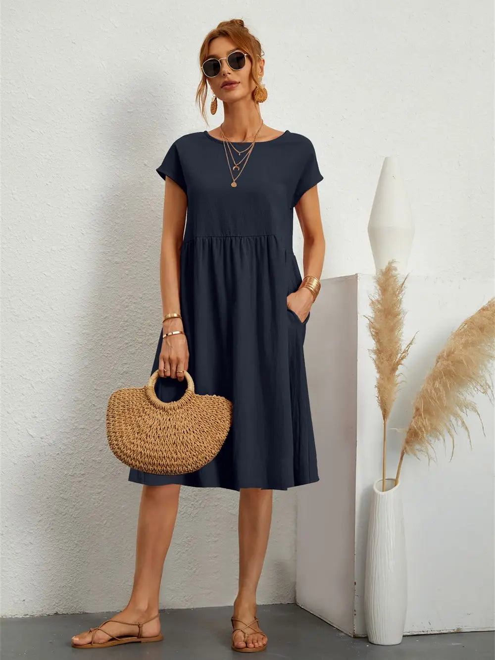 Effortless women's casual A-line midi dress with short sleeves and practical pockets.