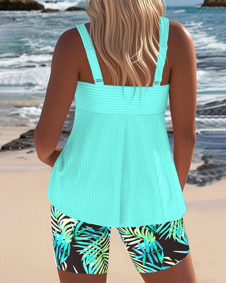Women's colorful tankini swimsuit with athletic design, perfect for beach vacations.