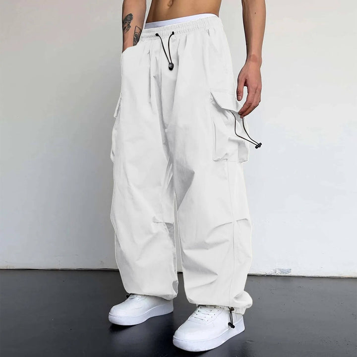 Detail of the elastic waistband & drawstring on unisex relaxed fit cargo joggers, comfort focused.