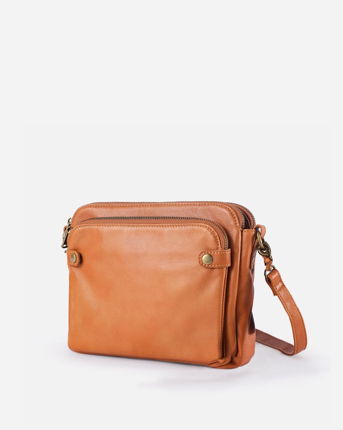 Spacious women's leather crossbody bag, fits a tablet, perfect travel & organizer purse.