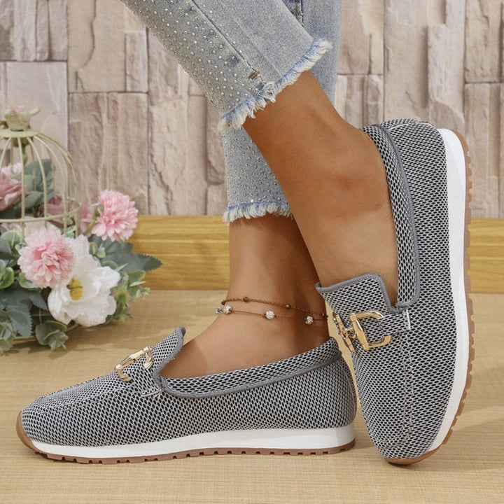 Simple yet chic women's lace-up flat sneakers, minimalist style, offering versatile everyday comfort.