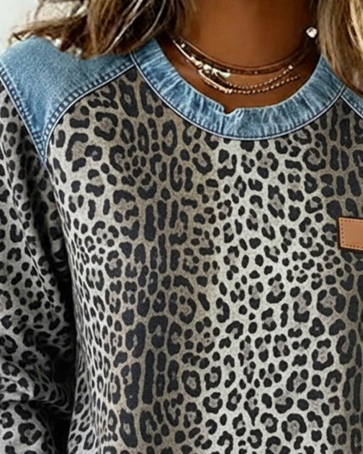 Soft women's leopard print knit sweater. Comfortable long-sleeve pullover, ideal for chic fall and winter fashion.