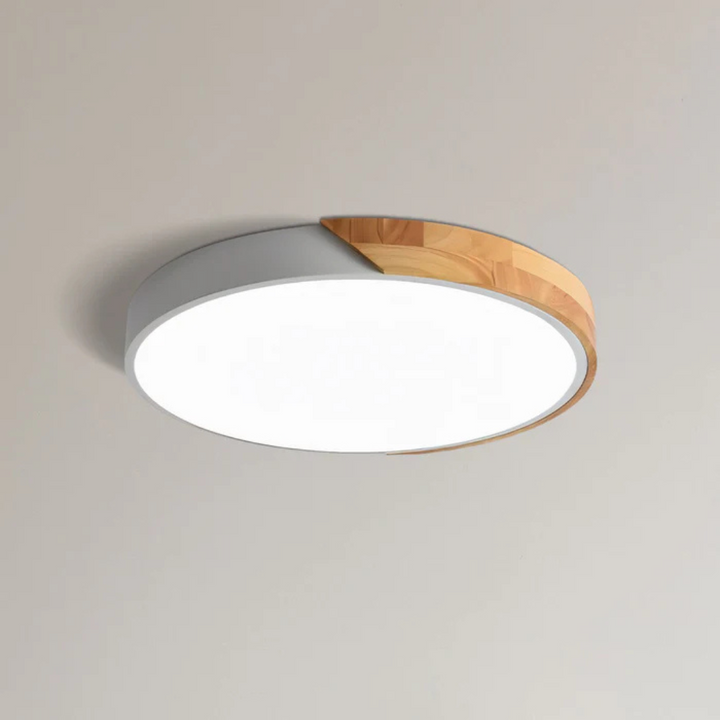 Dimmable flush mount LED ceiling light with natural wood, modern Scandinavian interior design.