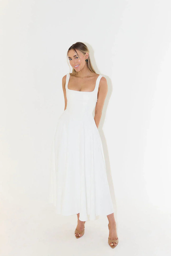 Women's white midi dress featuring a flattering square neck and flared silhouette.