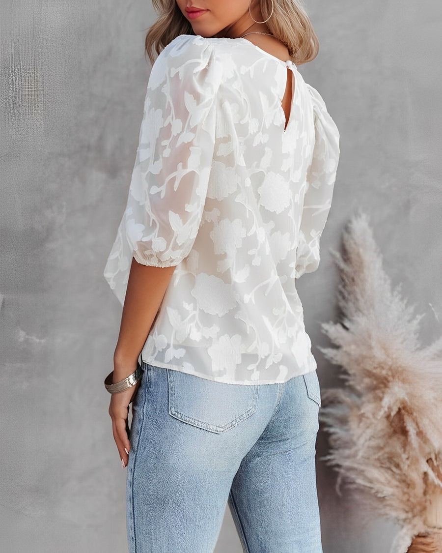 Chic women's top featuring elegant puff sleeves, a stylish blouse for a sophisticated look.