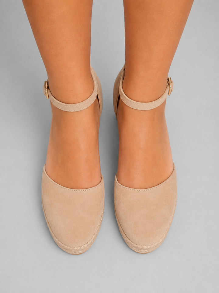 Close-up of espadrille wedge sandal, showcasing natural braided jute sole and secure ankle strap.