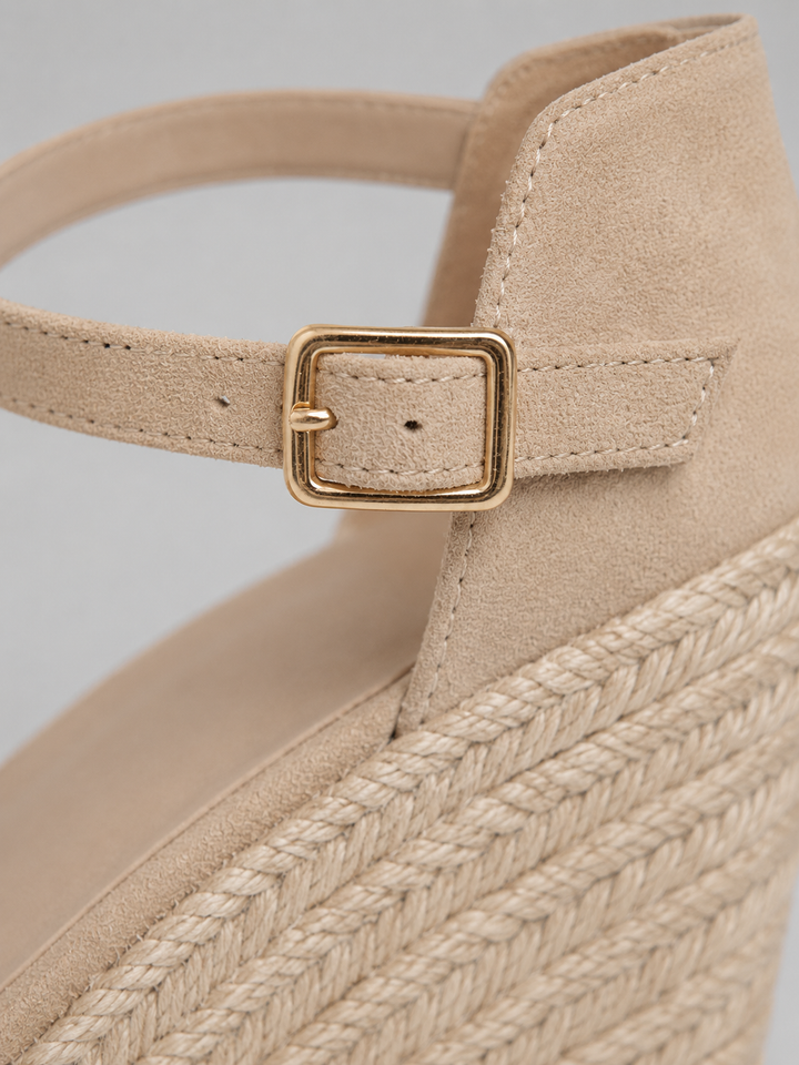 Stylish women's espadrille wedge sandals featuring a secure ankle strap and comfortable wedge.