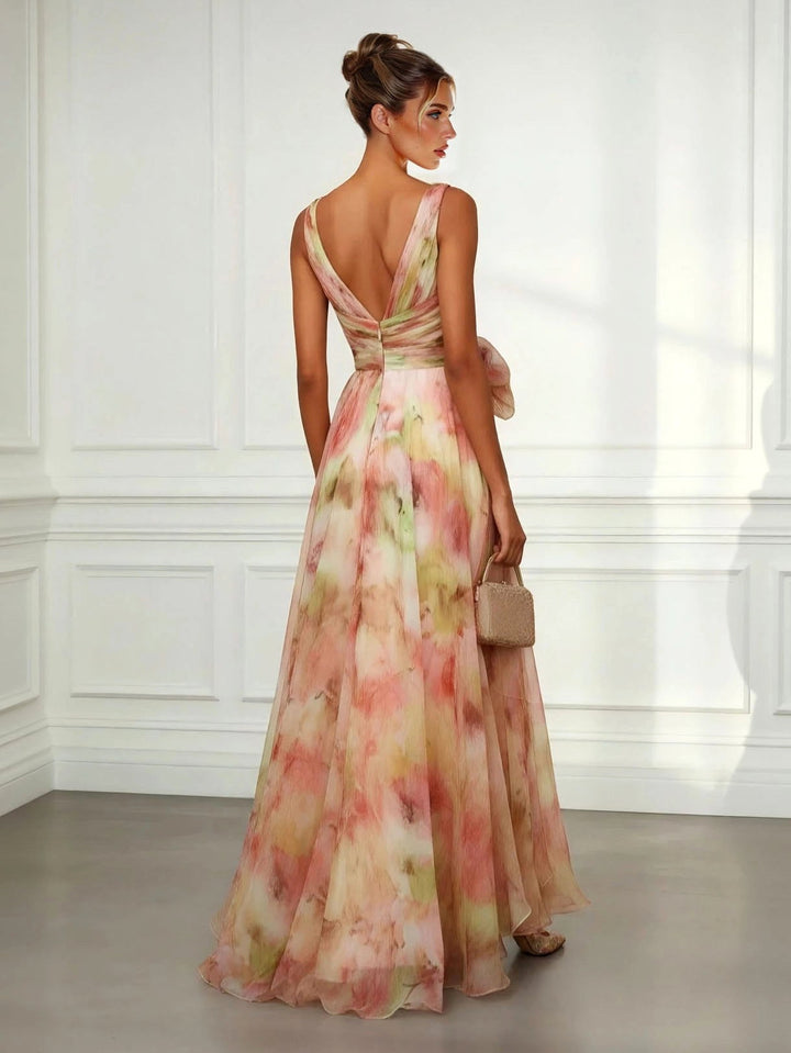 Flowy women's abstract print maxi dress, featuring a colorful design, V-neck, and stylish tie-waist.
