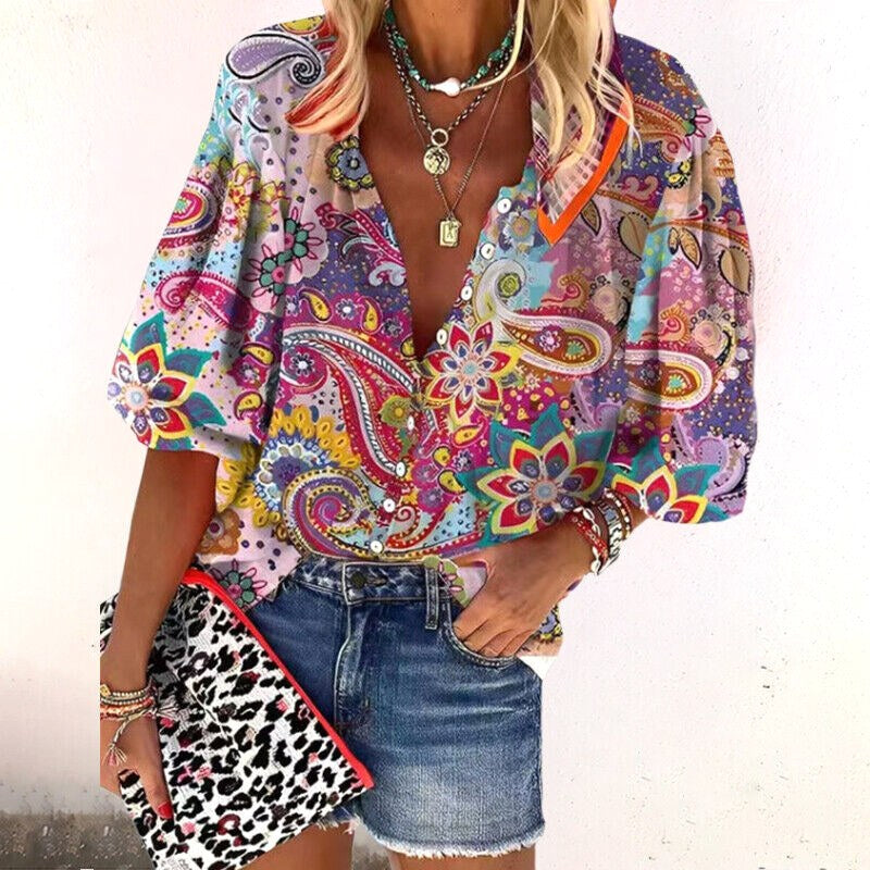 Flowy women's bohemian blouse with vibrant floral print and V-neck. Relaxed fit for effortless summer style.