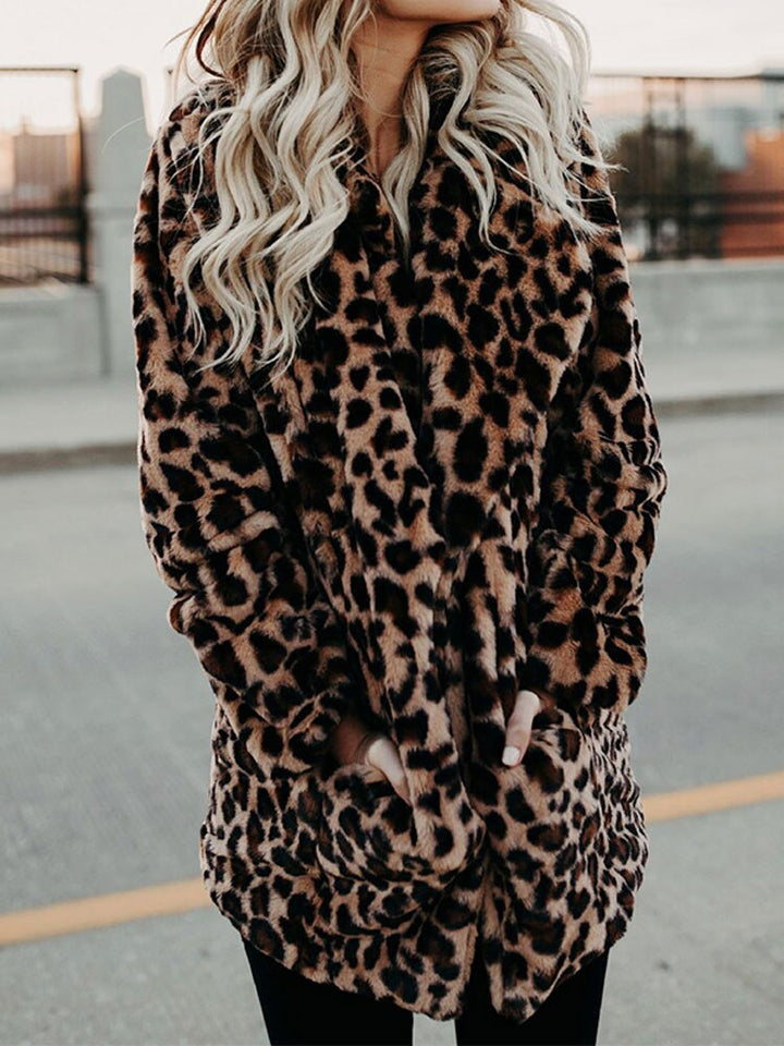 Trendy women's leopard print winter coat, a chic statement piece for bold fashion and warm outerwear in cold weather.