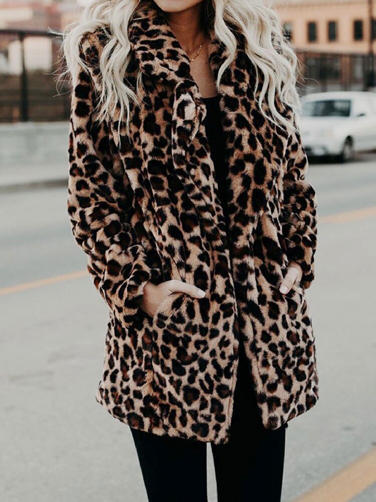 Detailed close-up of a women's leopard print winter coat, highlighting the chic pattern and warm, fashionable fabric.