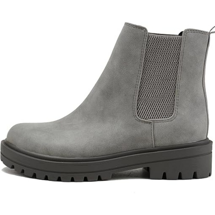 Close-up of women's chic low heel Chelsea ankle boots. Elegant design, perfect for fall & winter style.