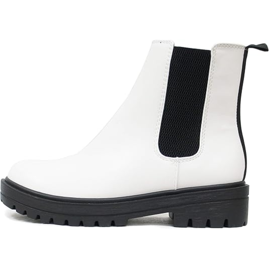 Women's low heel Chelsea ankle boots paired with jeans. Stylish and versatile fall fashion footwear.