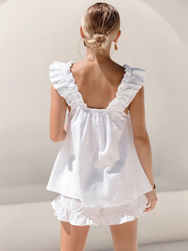 Chic feminine white ruffle shorts set for women. This summer two-piece outfit is perfect for casual or resort wear.