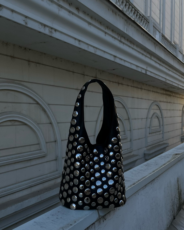 Chic women's black studded rivet shoulder bag, a stylish fashion accessory for evening or statement wear.