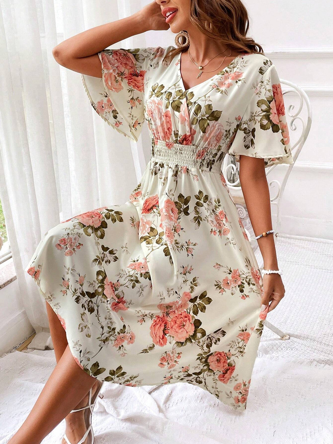 Graceful women's floral midi dress with flutter sleeves, V-neck, and smocked waist for spring/summer.