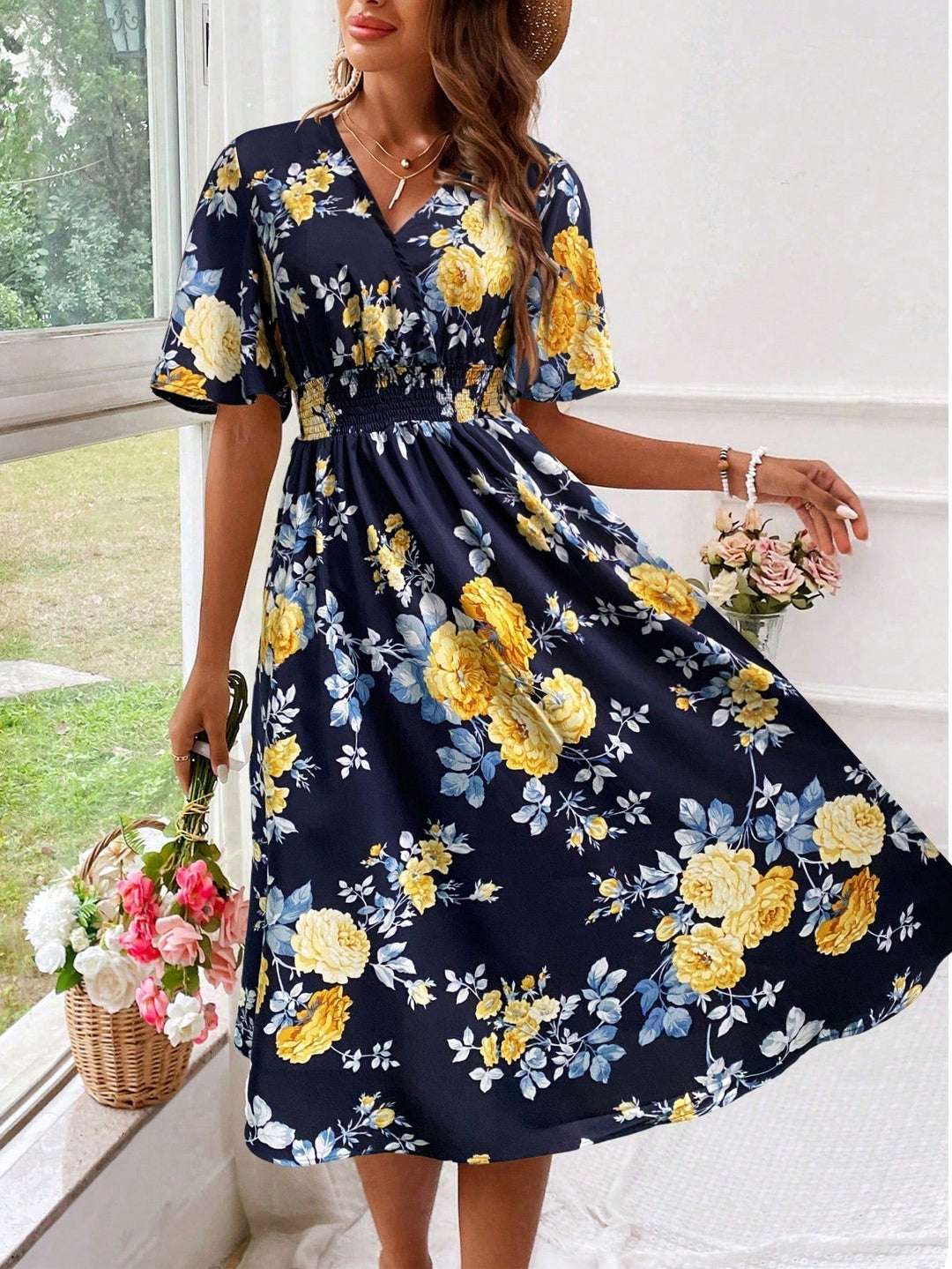 Stylish women's A-line floral midi dress, V-neck, flutter sleeves, and smocked waist for a charming look.