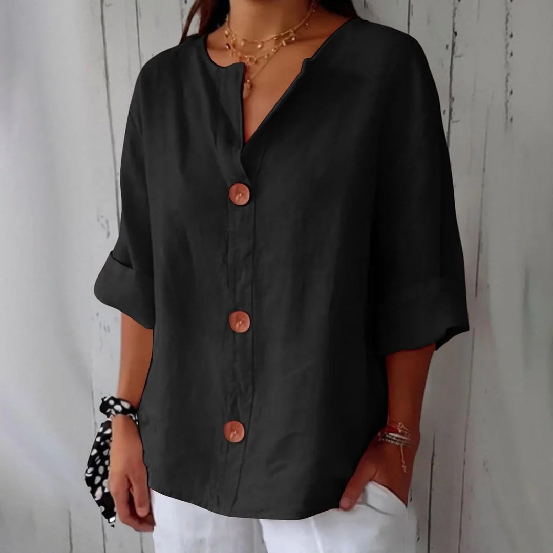 Comfortable women's oversized top with button front and three-quarter sleeves.