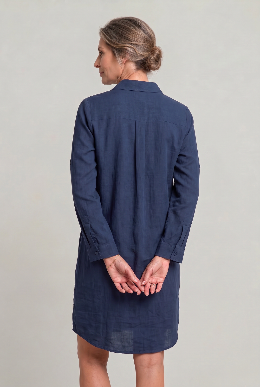Back view of women's oversized button-down shirt dress, highlighting relaxed fit, ideal as a casual summer dress.