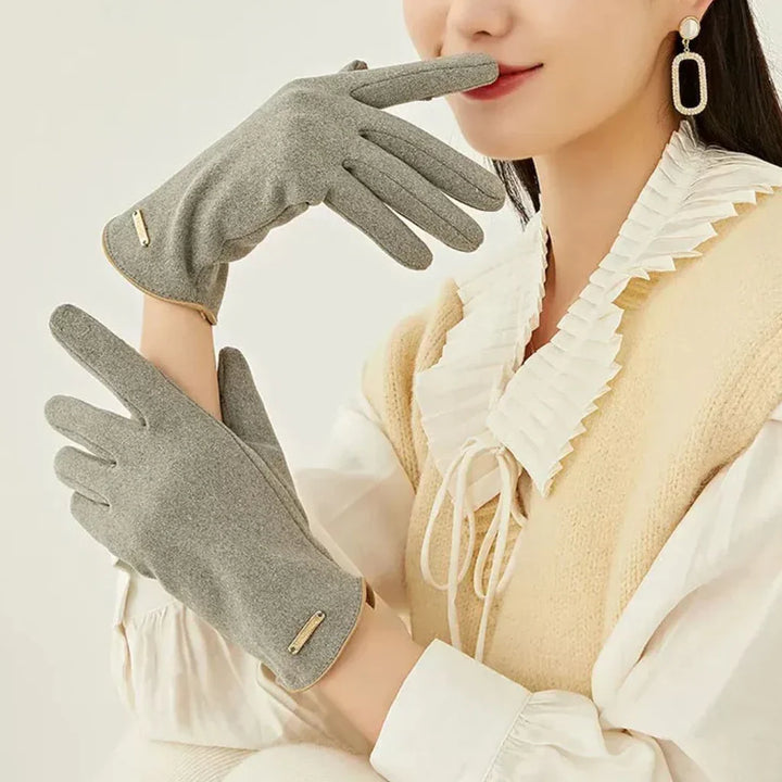 Chic pink women's suede touchscreen gloves, providing warmth & style in winter.