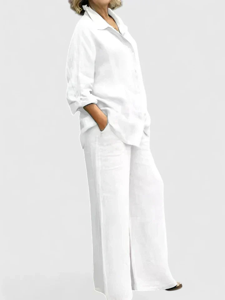 Woman walking in an effortless women's summer outfit: button-down shirt & wide-leg pants. Flowy, comfortable fashion.