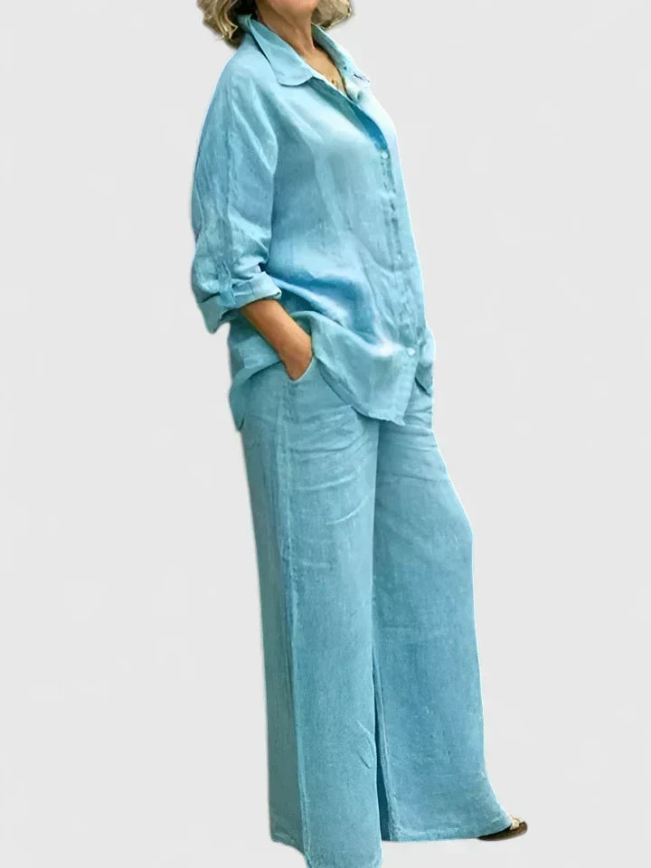 Folded women's casual set: button-down shirt & wide-leg pants. Easy to pack, versatile outfit for travel or home.