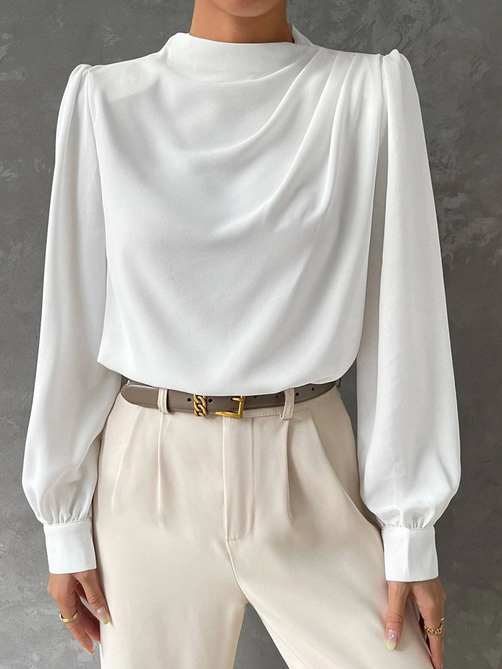 Flowy women's blouse with bishop sleeves, ideal for all-season wear and chic fashion looks.