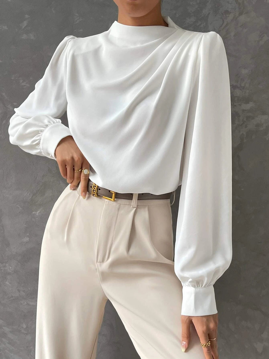 Detailed shot of the voluminous bishop sleeves on a women's elegant long sleeve blouse.