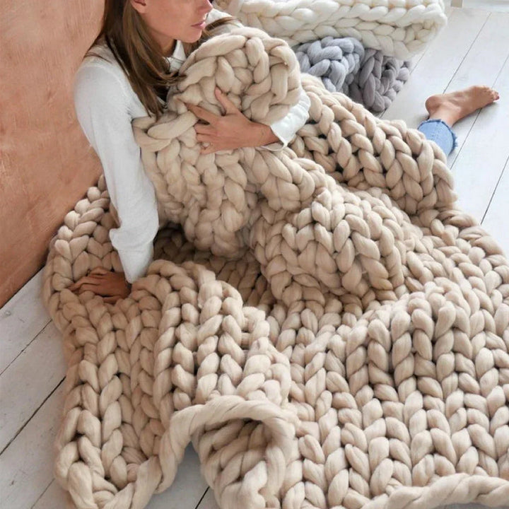Hand-knitting with thick, soft super chunky yarn to create a beautiful, cozy throw blanket.