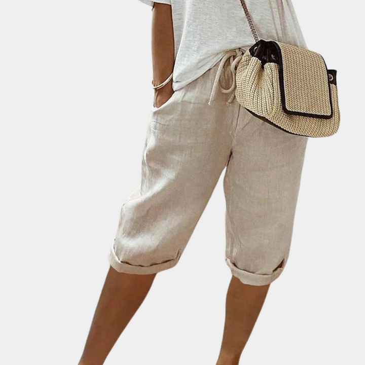 Woman wearing comfortable elastic summer shorts, enjoying a casual day out. Versatile & stylish.