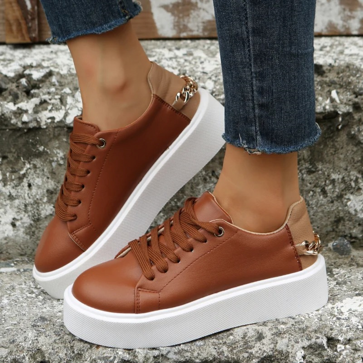 ComfortStep women's white leather sneakers with stylish metallic chain detail. Perfect for fashion & everyday wear.