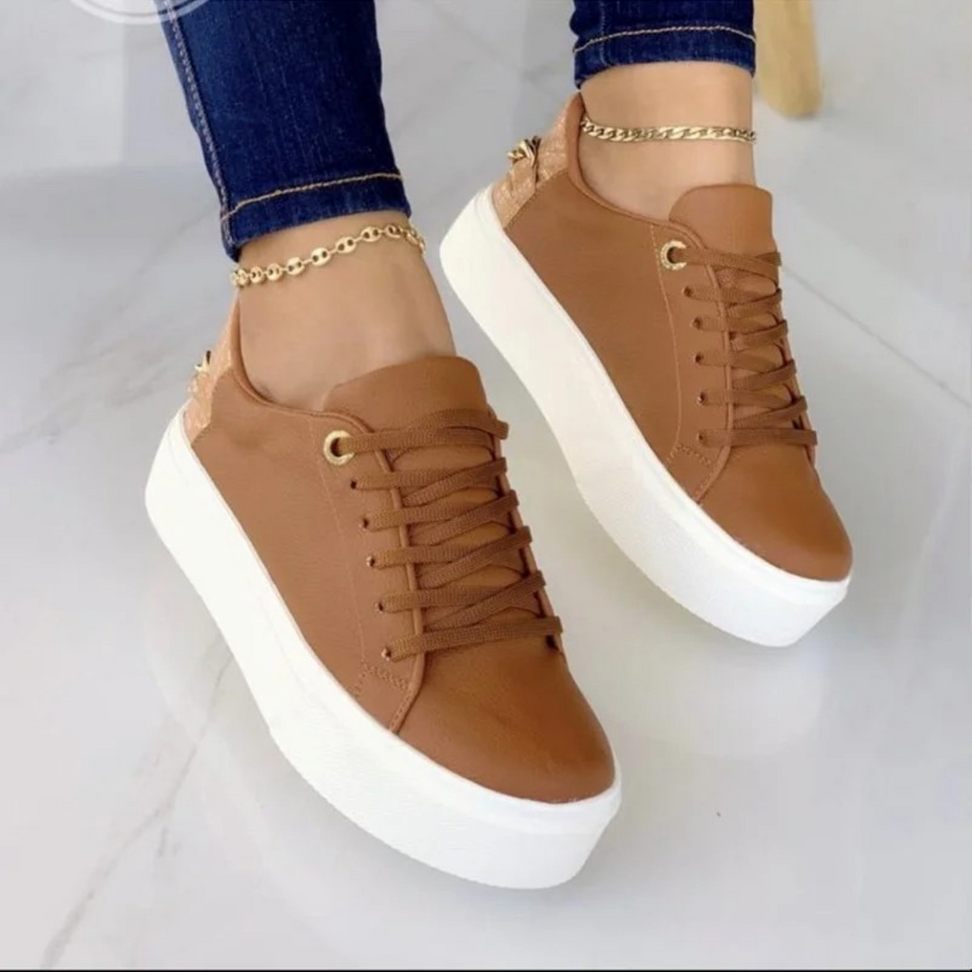 Comfortable white women's sneakers with premium leather & a striking metallic chain. Versatile for daily fashion.