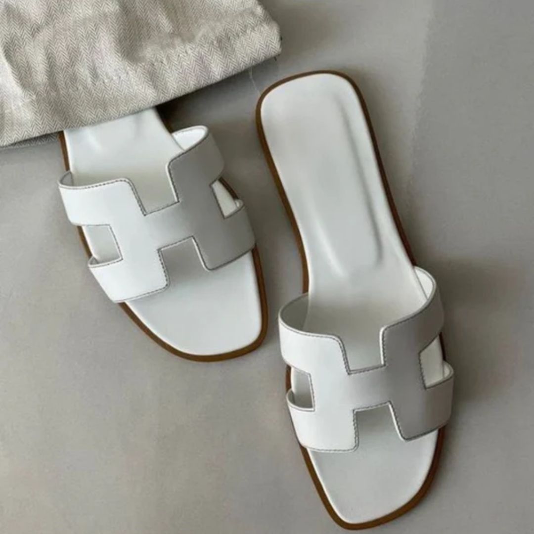 Chic Women's Cora slip-on sandals, perfect for comfortable everyday summer wear. Stylish open-toe flat footwear.