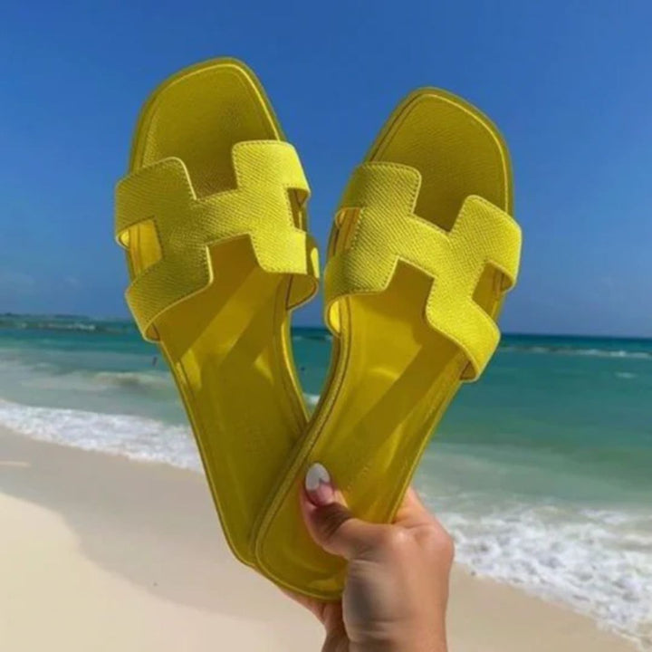 Stylish women's Cora flat sandals in a versatile slip-on design, ideal for casual or elegant summer fashion.